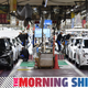A photo of cars rolling off two production lines at a Toyota factory.